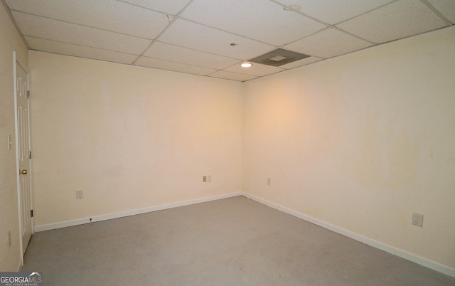 unfurnished room with recessed lighting, a drop ceiling, and baseboards