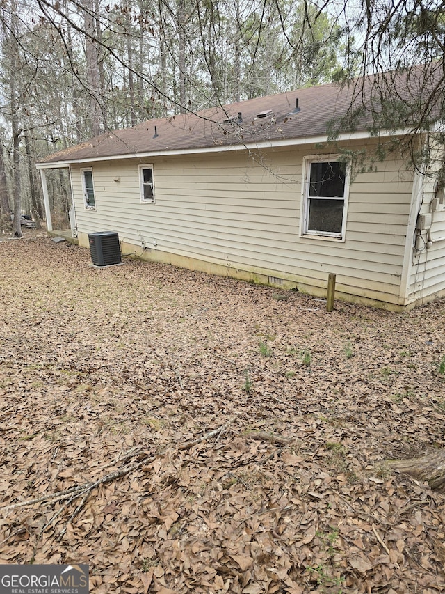 back of property with crawl space and central air condition unit