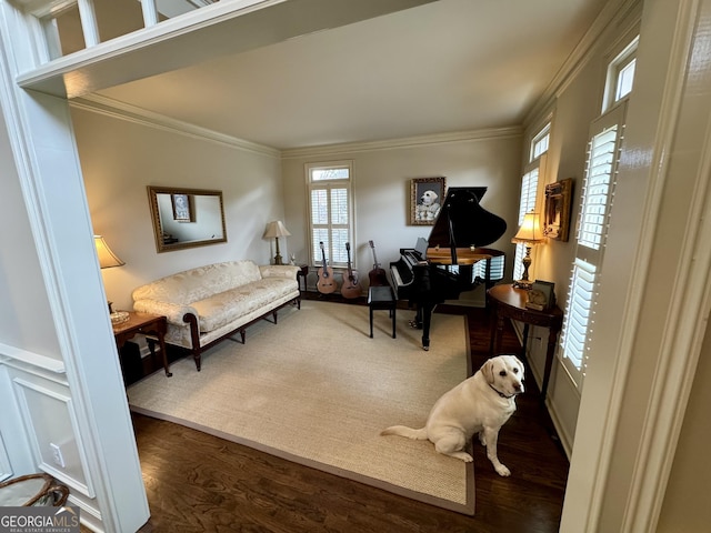 sitting room with wood finished floors and crown molding