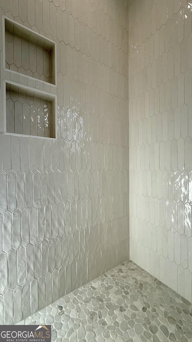 interior space featuring tiled shower