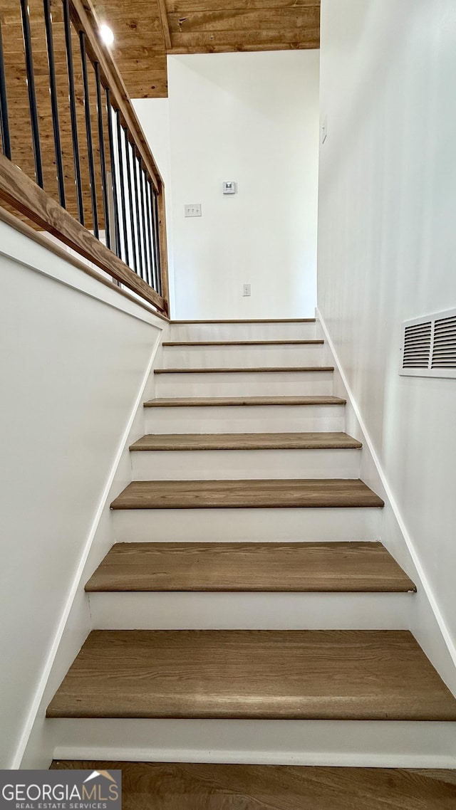 stairs featuring wooden ceiling and visible vents