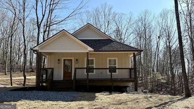 view of front of house featuring a shingled roof and a porch