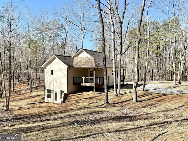 view of front of property featuring roof with shingles