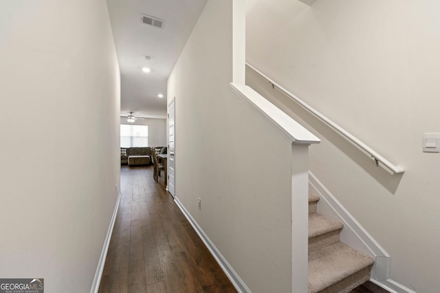 corridor with baseboards, visible vents, dark wood-type flooring, stairs, and recessed lighting