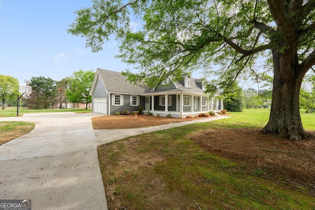 cape cod home featuring driveway, an attached garage, a porch, and a front yard