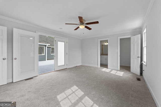 unfurnished bedroom featuring visible vents, baseboards, ornamental molding, and light colored carpet