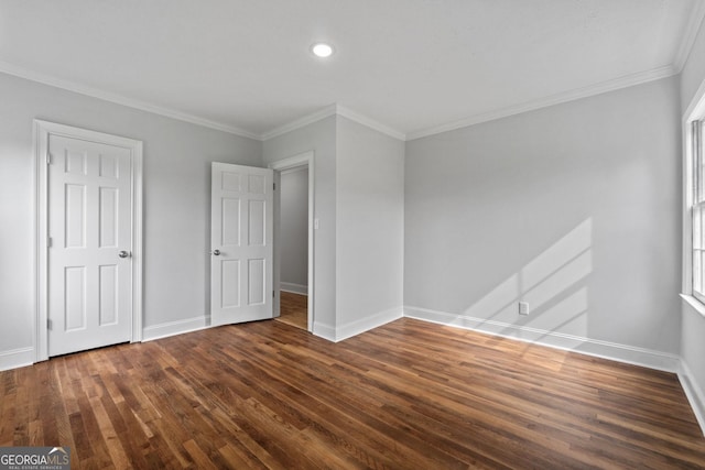 unfurnished bedroom with dark wood-style floors, multiple windows, crown molding, and baseboards