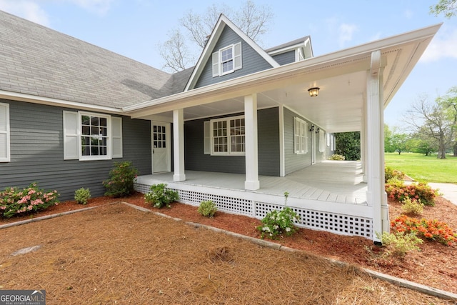 view of front of house with covered porch and roof with shingles