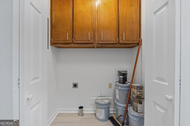 laundry room with cabinet space, baseboards, and electric dryer hookup