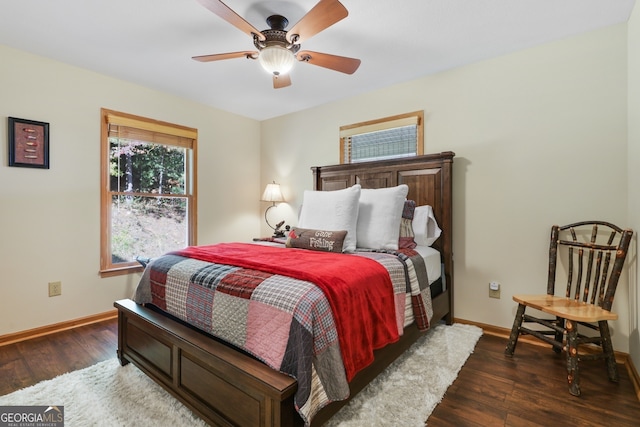 bedroom featuring dark wood-style floors, baseboards, and a ceiling fan