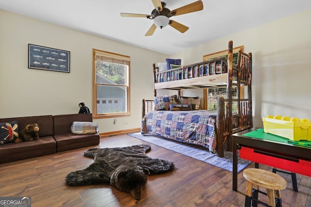 bedroom featuring ceiling fan, wood finished floors, and baseboards