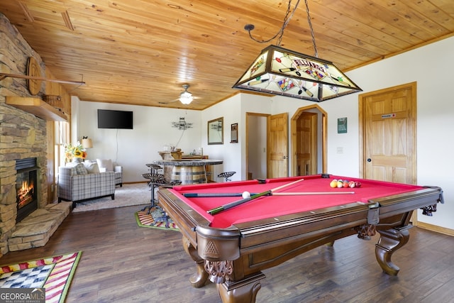 recreation room featuring arched walkways, a stone fireplace, wooden ceiling, and dark wood finished floors