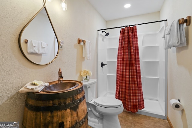 bathroom with tile patterned flooring, a shower stall, toilet, and vanity