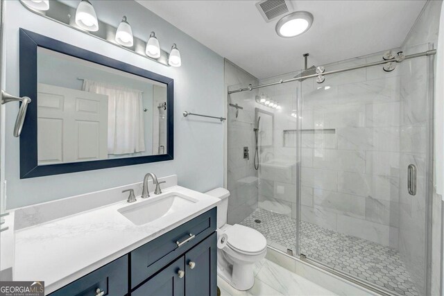 bathroom with marble finish floor, visible vents, toilet, a stall shower, and vanity