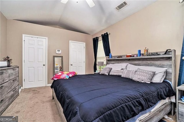 bedroom with light carpet, ceiling fan, vaulted ceiling, and visible vents