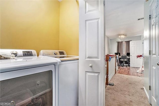 laundry room with light carpet, laundry area, washer and clothes dryer, and visible vents