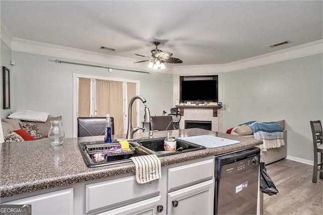 kitchen featuring a sink, visible vents, open floor plan, black dishwasher, and ornamental molding