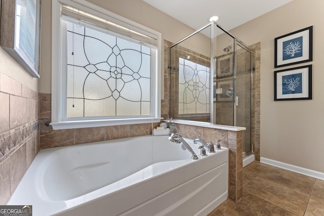702 Berkeley Ter, Canton, GA 30115 - full bath featuring a garden tub, a shower stall, and baseboards