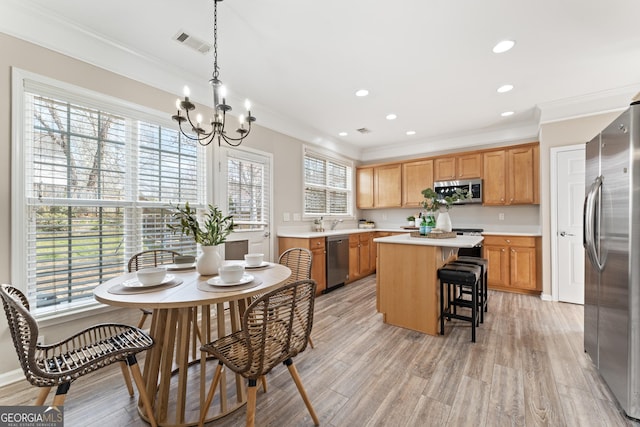 702 Berkeley Ter, Canton, GA 30115 - kitchen featuring stainless steel appliances, a chandelier, a kitchen island, ornamental molding, and light countertops