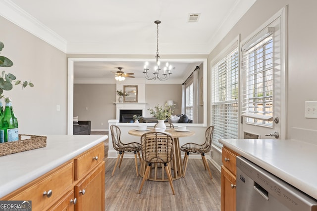 702 Berkeley Ter, Canton, GA 30115 - dining area with a fireplace, light wood finished floors, ornamental molding, a chandelier, and baseboards