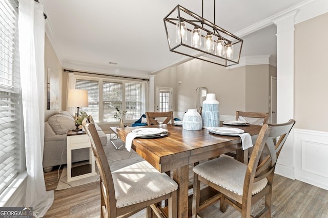 702 Berkeley Ter, Canton, GA 30115 - dining space with crown molding, light wood-style flooring, and a wainscoted wall