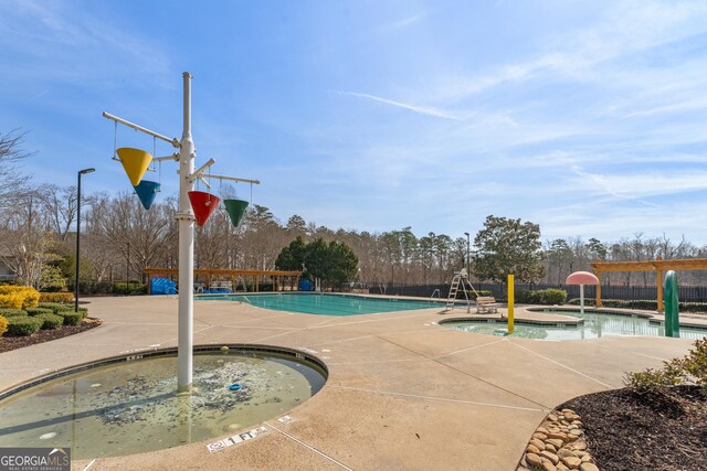 702 Berkeley Ter, Canton, GA 30115 - community pool featuring a hot tub, a patio area, and view of wooded area