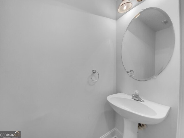 641 Morningside Dr, Stockbridge, GA 30281 - bathroom with a sink and baseboards