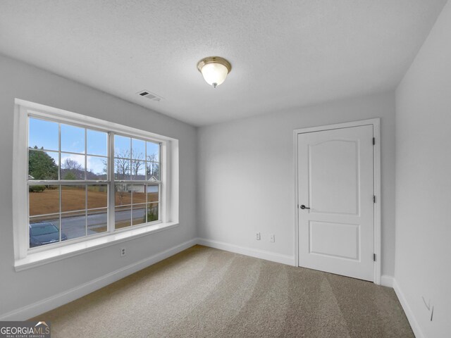 641 Morningside Dr, Stockbridge, GA 30281 - carpeted spare room with baseboards, visible vents, and a textured ceiling