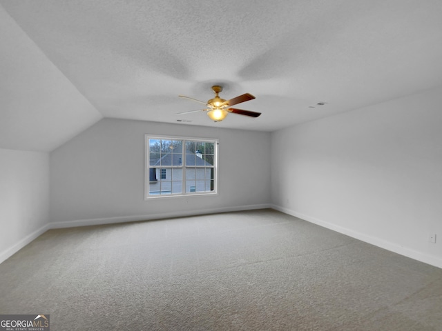 641 Morningside Dr, Stockbridge, GA 30281 - bonus room with carpet flooring, vaulted ceiling, a textured ceiling, and baseboards