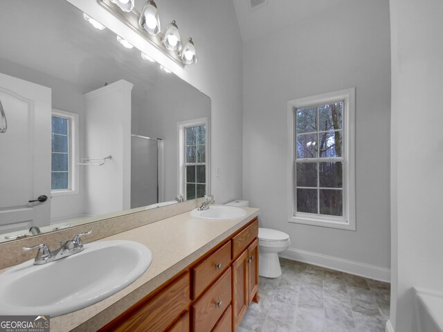 641 Morningside Dr, Stockbridge, GA 30281 - bathroom featuring double vanity, a stall shower, a sink, and baseboards