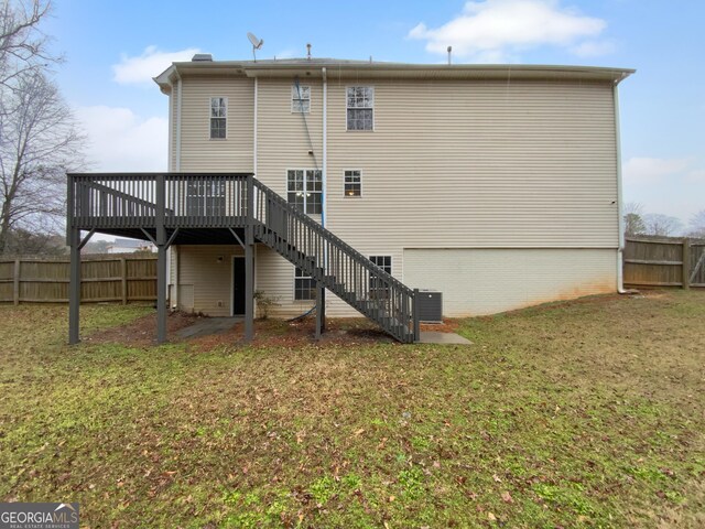 641 Morningside Dr, Stockbridge, GA 30281 - back of house featuring a garage, stairway, a yard, fence, and a wooden deck