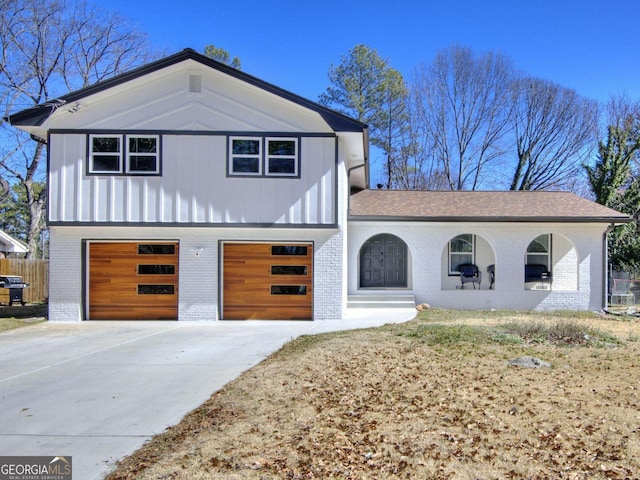 view of front of property with driveway, an attached garage, and brick siding