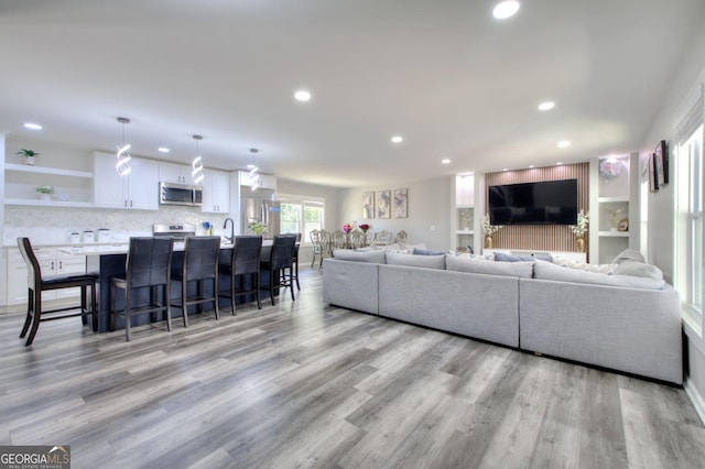 living room with recessed lighting and light wood finished floors