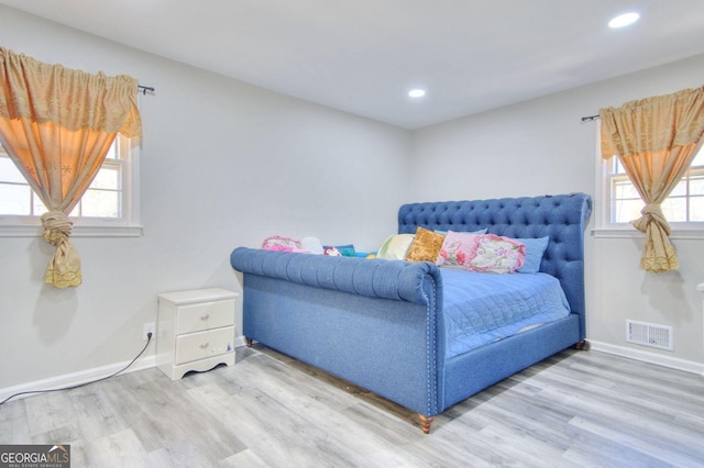 bedroom with recessed lighting, visible vents, baseboards, and wood finished floors