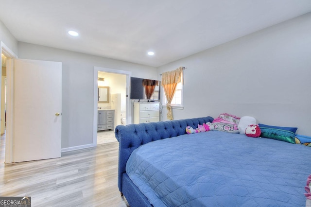 bedroom featuring baseboards, light wood-type flooring, ensuite bath, and recessed lighting