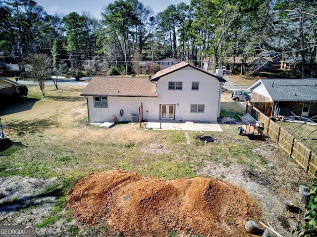 back of house featuring cooling unit, a patio area, a fenced backyard, and a yard