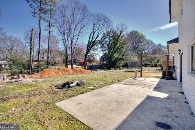 view of yard with a patio and a trampoline