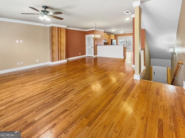 unfurnished living room with ornamental molding, visible vents, light wood-style flooring, and baseboards