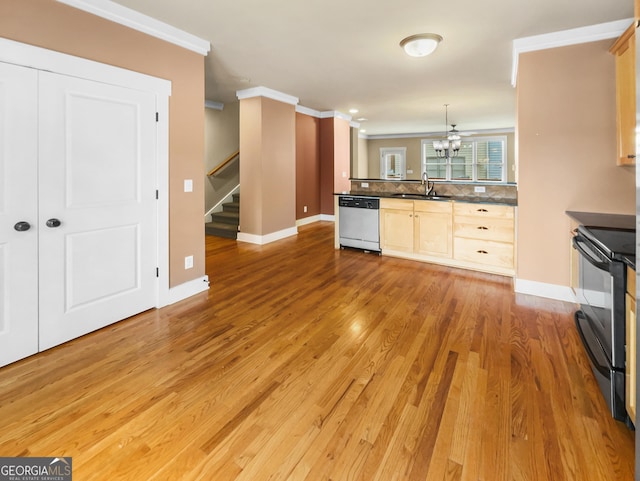 kitchen featuring ornamental molding, dark countertops, electric stove, and stainless steel dishwasher