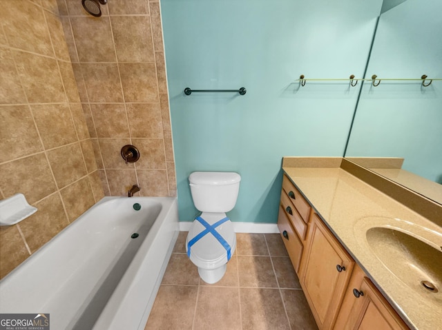 bathroom with shower / bathtub combination, toilet, vanity, baseboards, and tile patterned floors