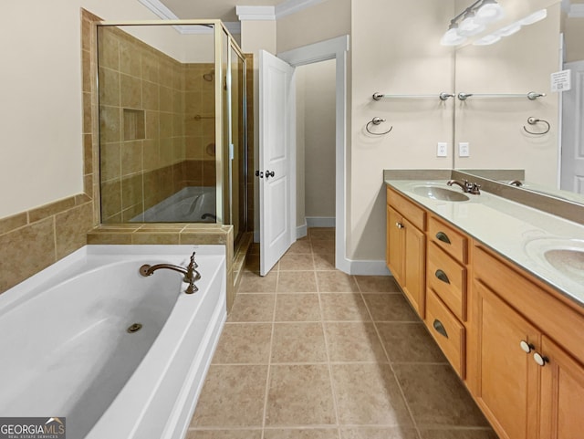 bathroom with a stall shower, a sink, a bath, and tile patterned floors