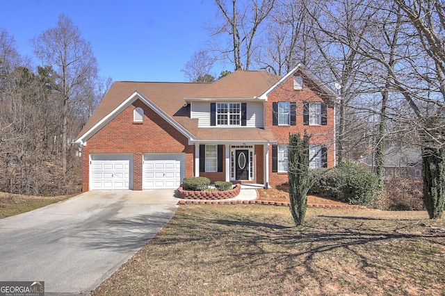 view of front of home with a garage, driveway, and brick siding