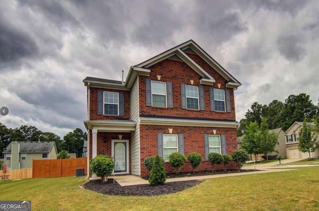 view of front of house with brick siding, fence, central AC, and a front yard