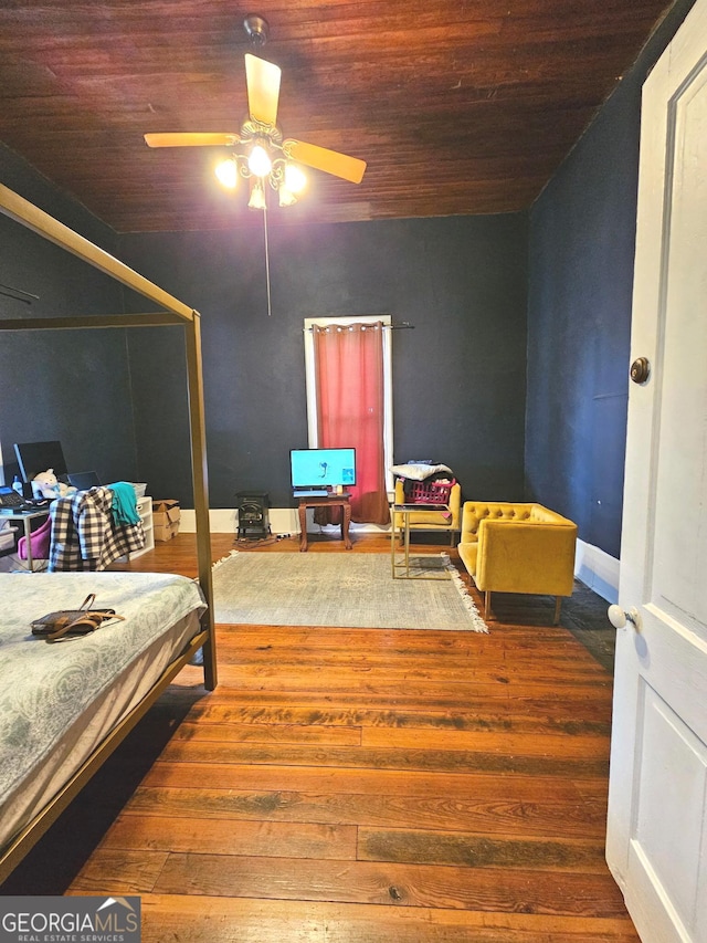 bedroom with wood ceiling, ceiling fan, baseboards, and wood finished floors