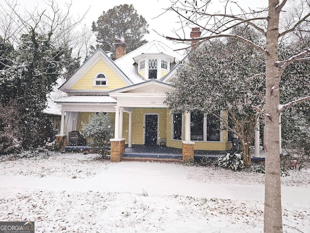 view of front of house with a porch and a chimney