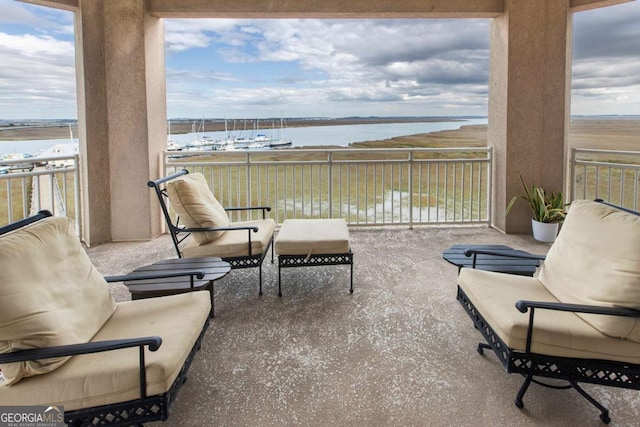 balcony featuring a water view and an outdoor hangout area