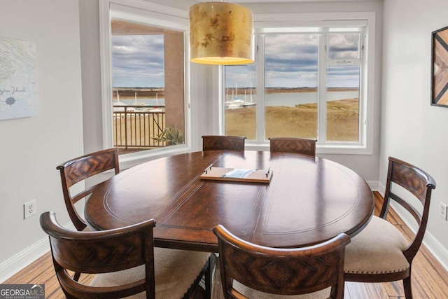 dining area featuring wood finished floors and baseboards