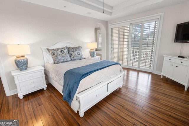 bedroom featuring dark wood finished floors, baseboards, and access to exterior