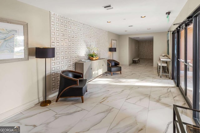 living area with recessed lighting, visible vents, marble finish floor, and baseboards