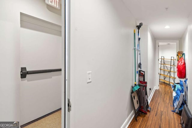 corridor with recessed lighting, baseboards, and wood finished floors